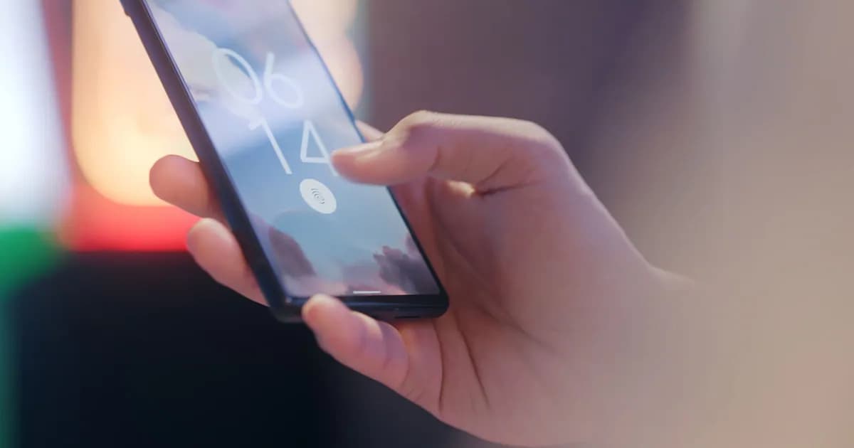 Close-up of a hand holding a smartphone locked with a fingerprint sensor