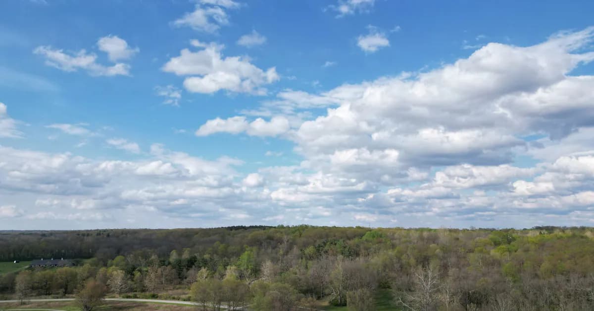 Aerial view of lush landscape with road cutting through fields and forests in Powell, Ohio