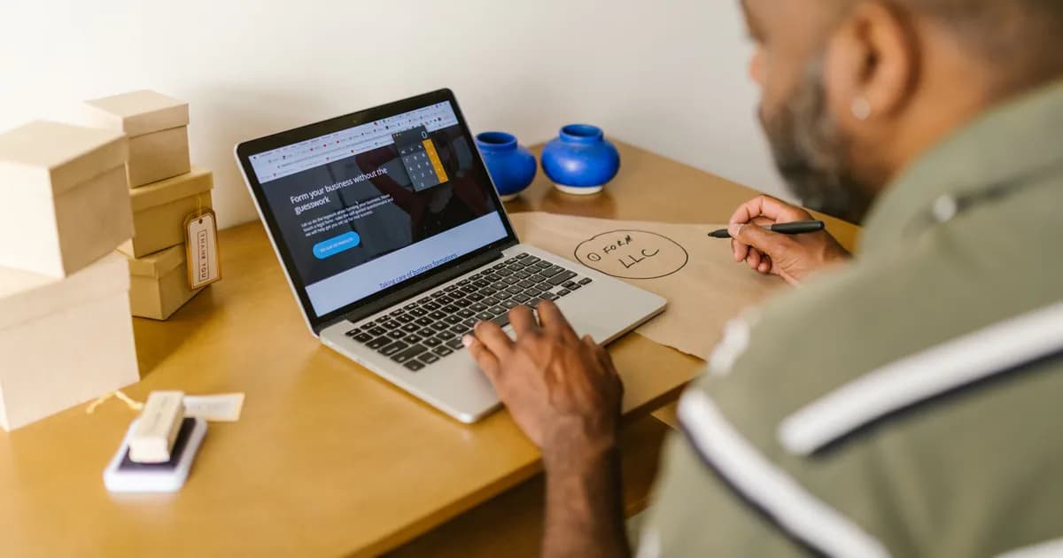 Entrepreneur at a desk using a laptop for business planning. Ideal for tech and startup themes