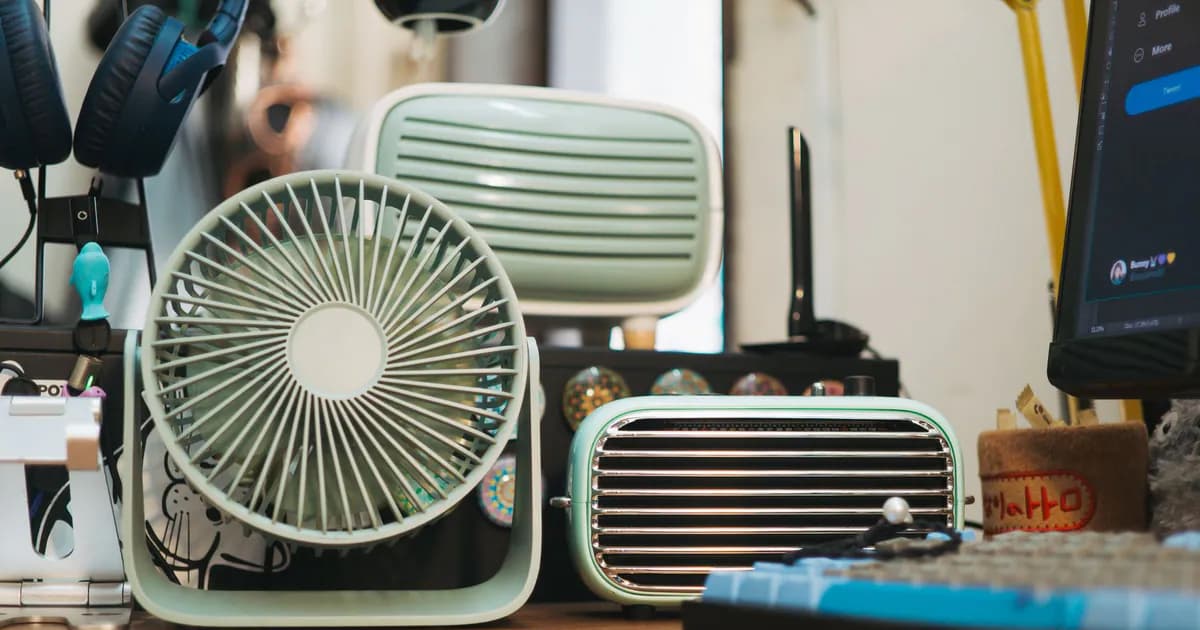 A variety of vintage electronic devices displayed on a wooden desk for a retro-themed interior