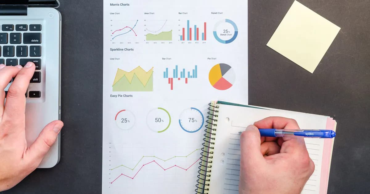 Hands interacting with charts and notes for data analysis on a desk