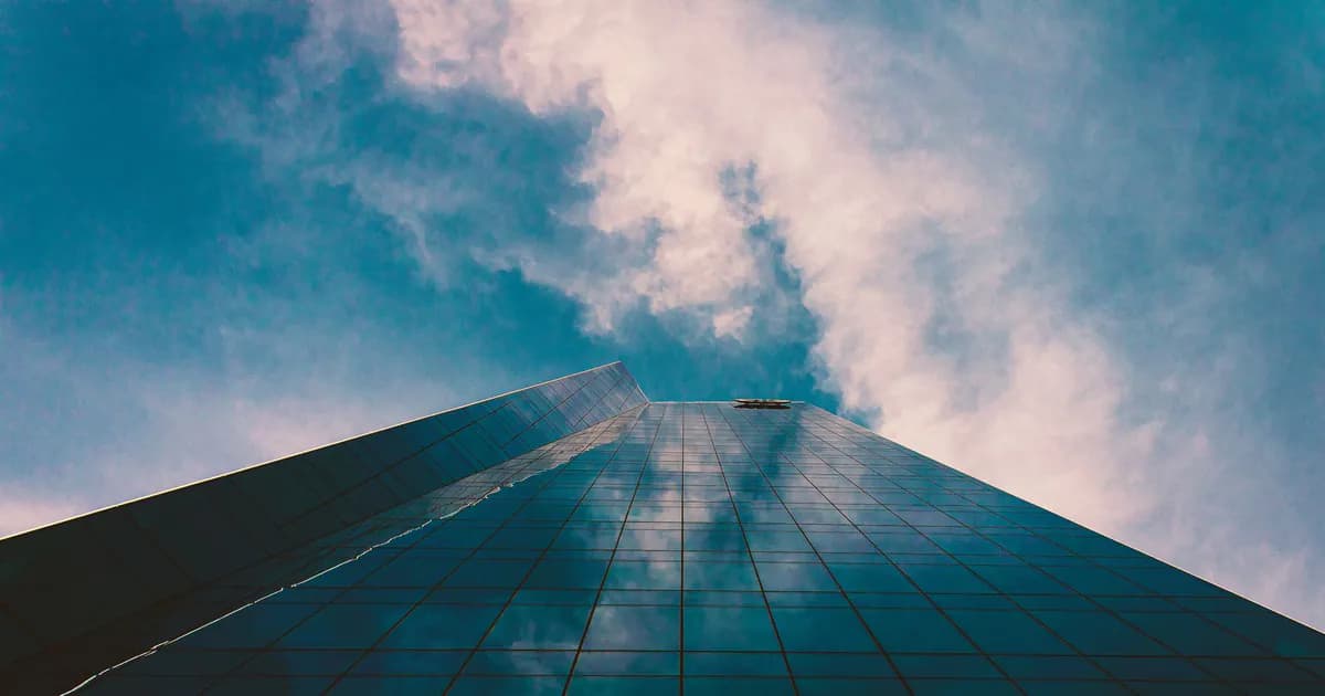 A towering modern skyscraper in San Antonio reflecting the sky's vibrant colors