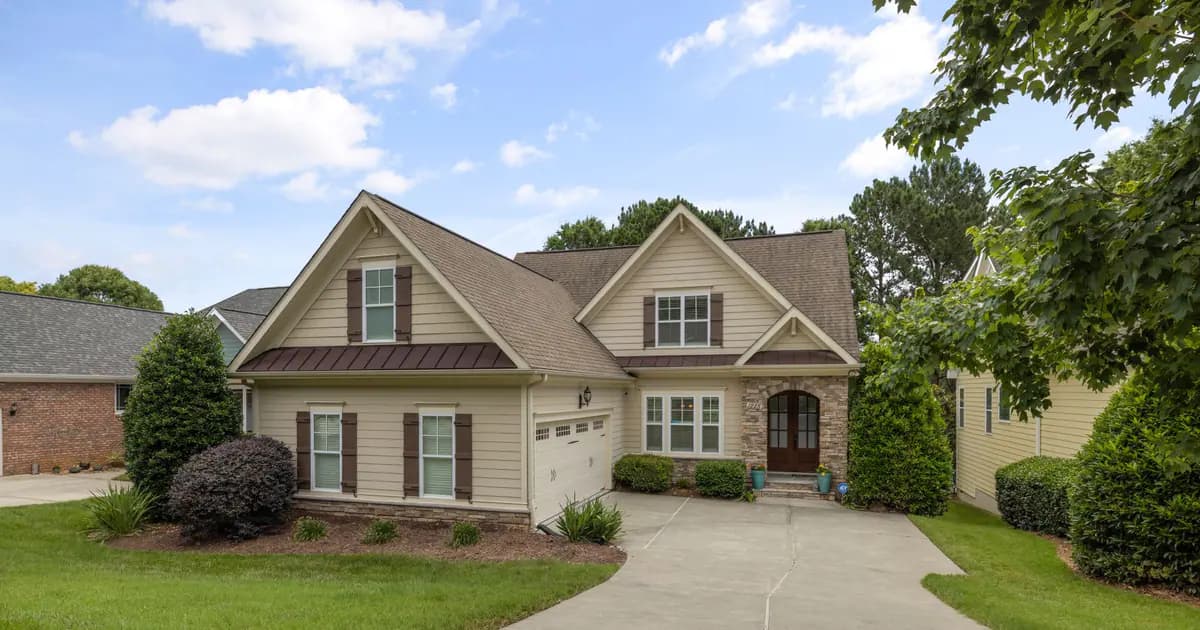 A beautiful suburban family house with a well-maintained lawn and driveway
