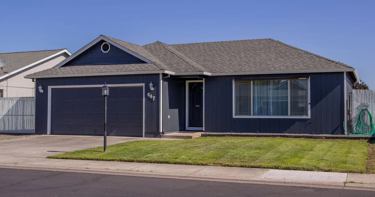 Charming suburban house with driveway, garage, and well-maintained lawn