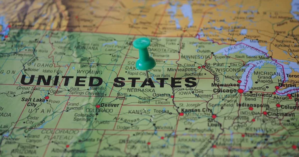 High-angle view of a map featuring the United States with a green pin indicating a specific location