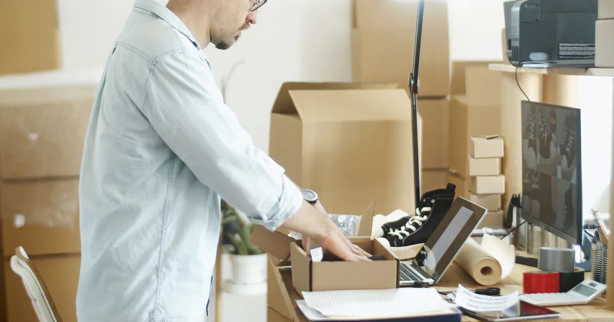Businessman packing products in a home office for an online store startup
