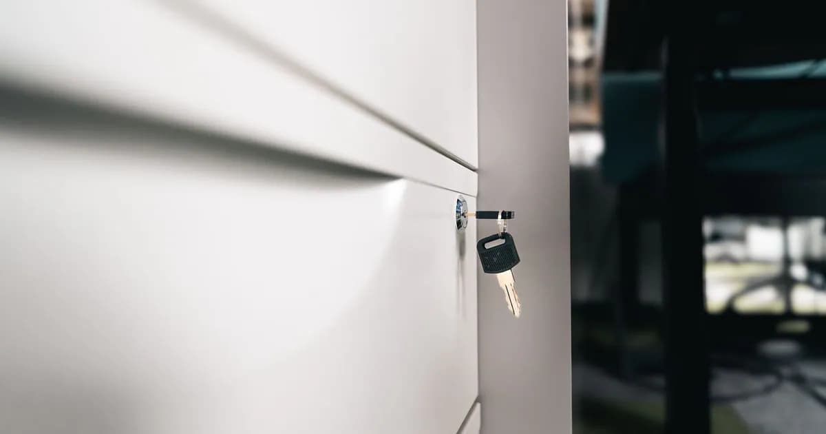 Close-up of a key in a locked office drawer for secure storage and privacy