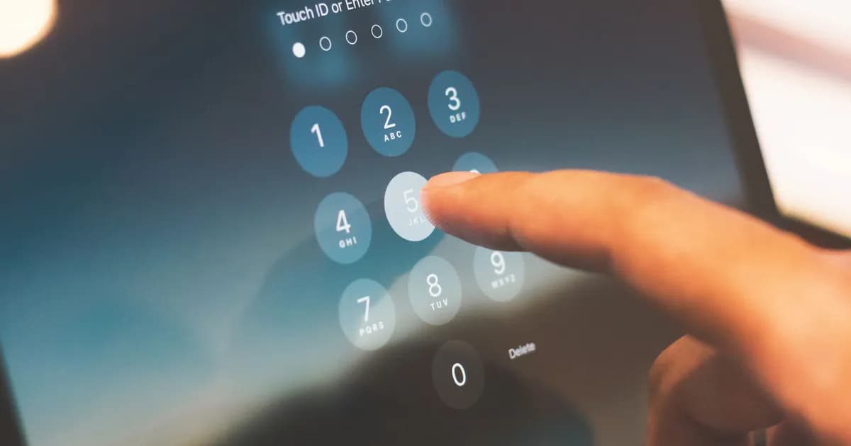 Close-up of a finger entering a passcode on a smartphone security screen