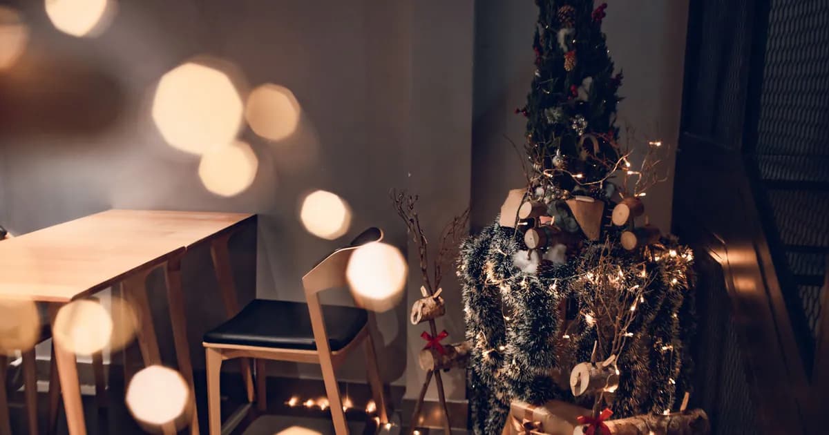 Warm and inviting Christmas corner with tree, gifts, and elegant lighting accents