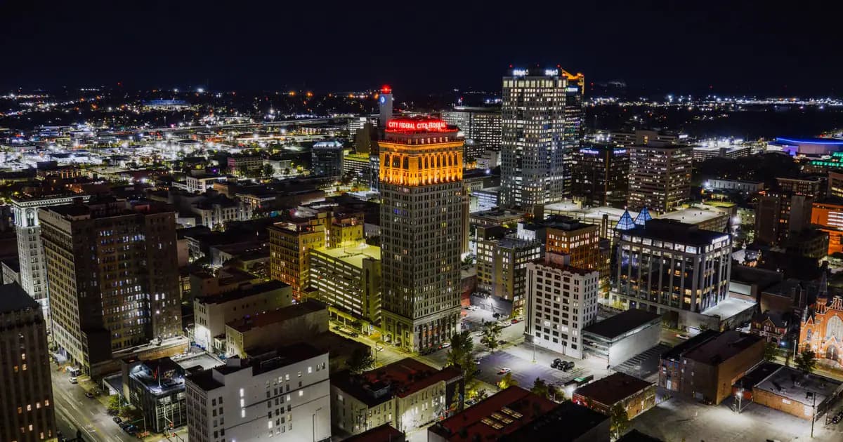 Stunning aerial view of Birmingham, Alabama at night showcasing the illuminated cityscape with prominent landmarks