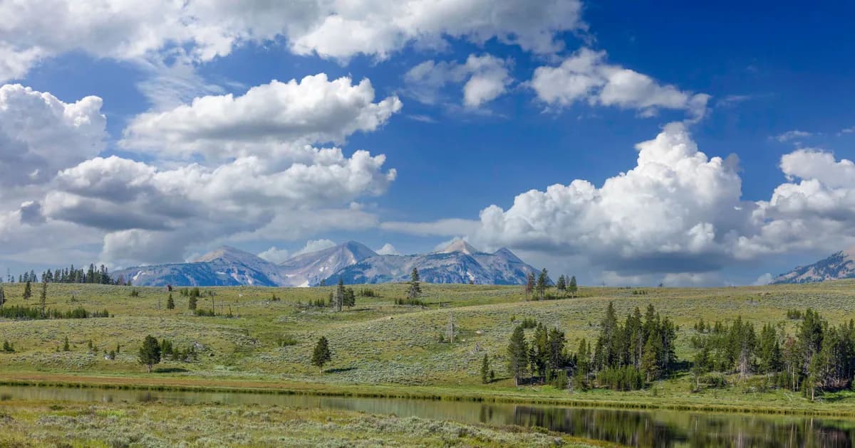 Beautiful mountain landscape in Wyoming with a serene lake and blue sky