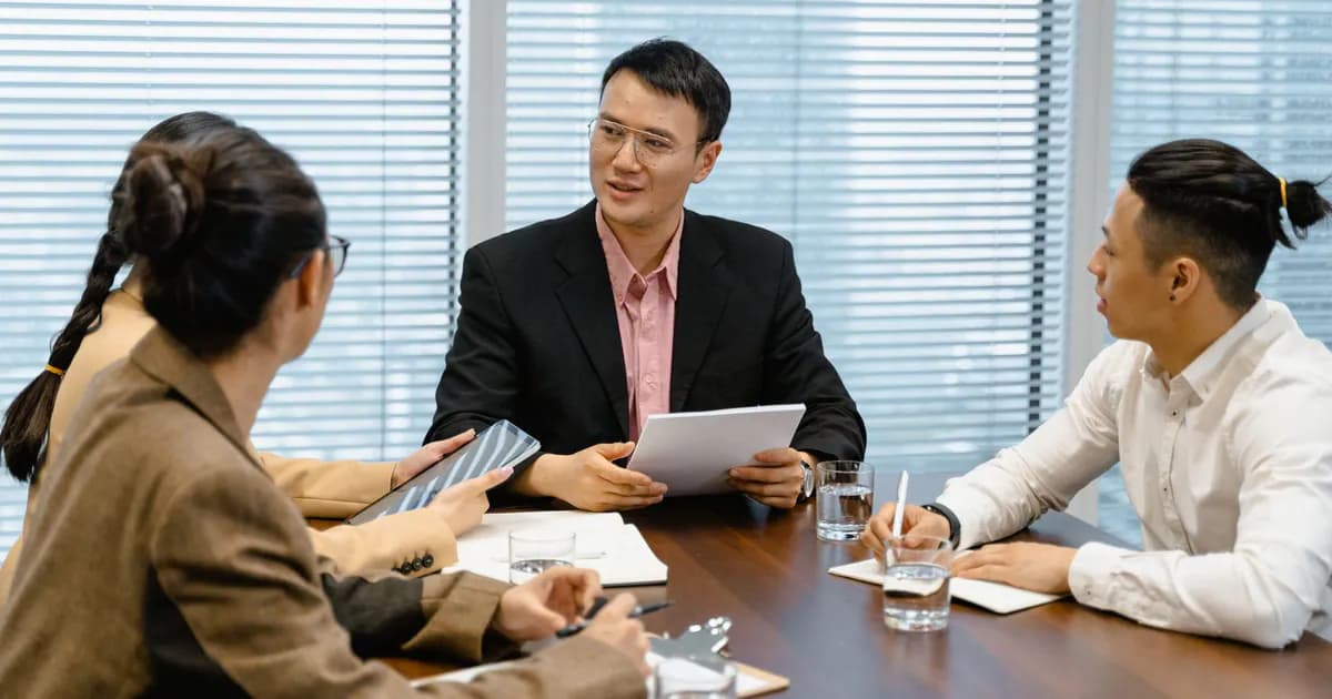 A group of business professionals having a discussion during a meeting in a modern office setting