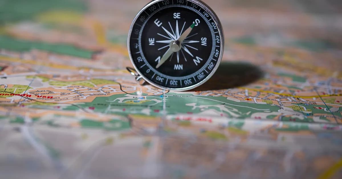 Black compass on detailed map symbolizing navigation and exploration