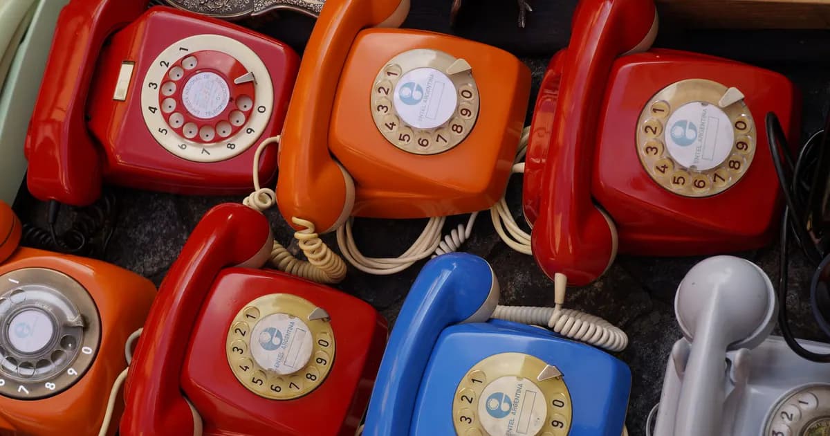 A collection of colorful vintage rotary telephones evokes nostalgic charm and retro style