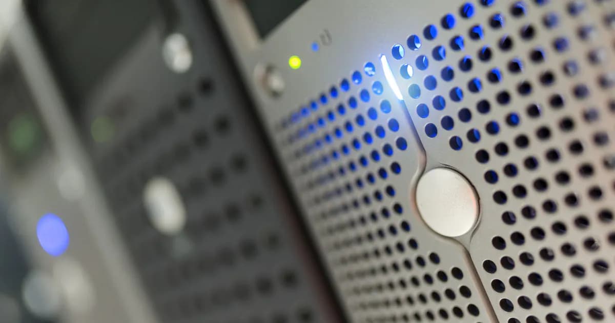 Focused detail of a modern server rack with blue LED indicators in a data center