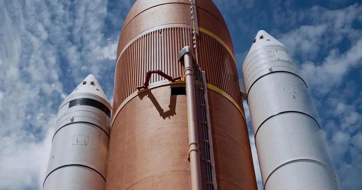 Dramatic view of rocket boosters against a bright blue sky