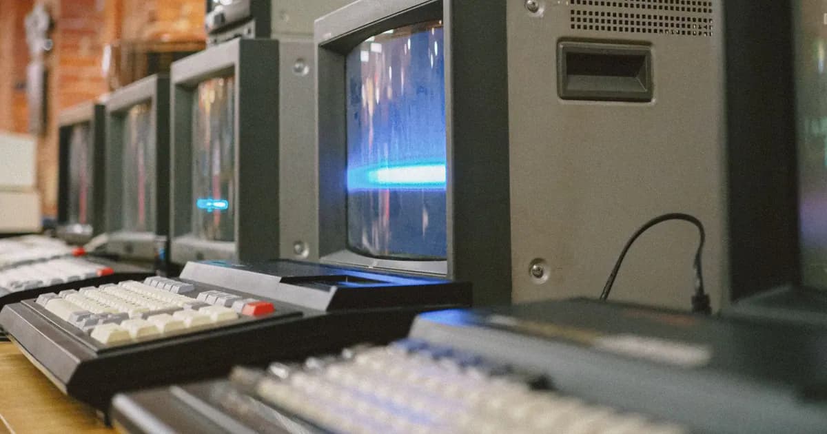 Row of vintage CRT computer monitors showcasing classic technology indoors