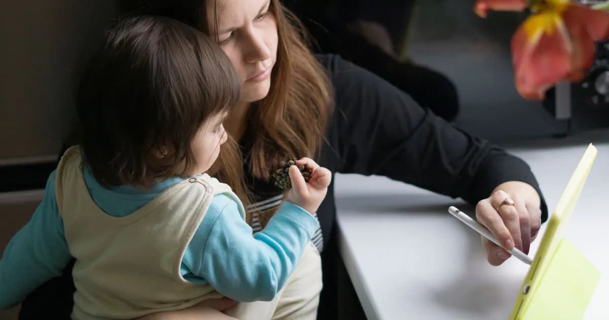 A mother and child engage with a tablet