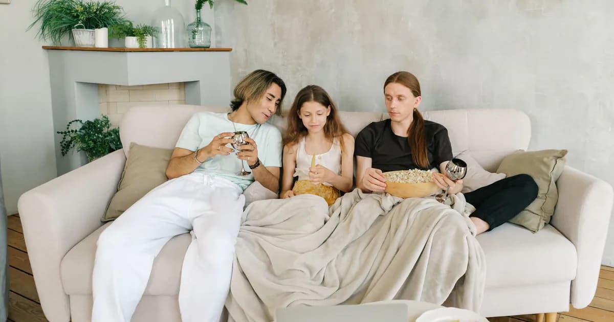 A family enjoys a cozy movie night with snacks and drinks, creating warm memories