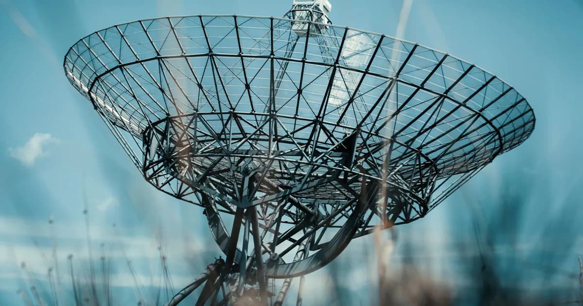A large satellite dish tower set against a clear blue sky