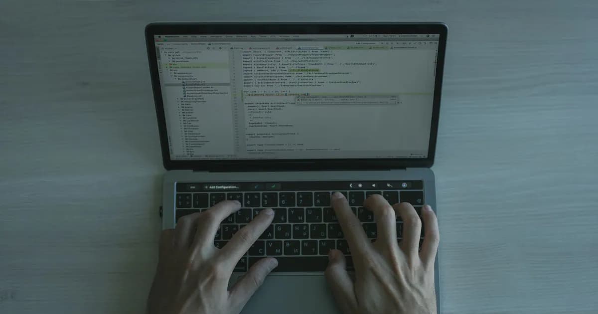 Close-up view of a programmer coding on a laptop
